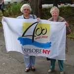 Historians Colette Fulton and Janet Dempsey with the Quadricentennial flag.