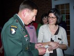 Cornwall Library Director, Karen LaRocca-Fels, presents Gen. Petraeus with his own library card.
