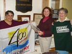 (L to R) Susan Kamlet, Maryanne Rose O'Dell and Dean Satterly, of the historical society, hold the items that will be buried in the time capsule.