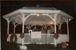 Members of the Stormy Weather Players lead a carol sing in the village bandstand.