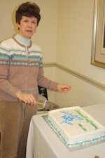 Deputy mayor Barbara Gosda cut a piece of the village's birthday cake.