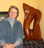 Maria Miller and one of her wood sculptures