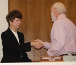 Mayor Gross congratulates Barbara Gosda after she was sworn into her second term as village trustee.  She was also re-appointed as deputy mayor.