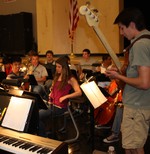 The student orchestra performs the dramatic score of Les Miserables.