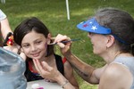 Volunteer Kate Benson painted the faces of dozens of smiling kids.