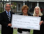 Susan Valentine, a member of the board of the Hudson Valley Food Bank, accepts a check from Catherine Grigorakis, of St. Nicholas Greek Church.  Also pictured is Valentine?s husband, Newburgh Mayor Nicholas Valentine.