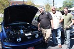Alan Southwell, center, shows off his Mustang to Michael Dacey and Sean Burgess, who work for him at the hospital's security department.