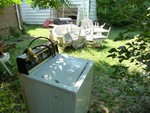 and a washing machine, wicker furniture and grill were left in the backyard.