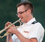 Sgt. Richard Johnson plays trumpet and creates a melodic sound. 