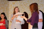 Jessica Hauserman, as Phyllis, passes out new dialogue script the day before the play opens.