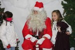 Santa listened to the wishes of young children at the firehouse.