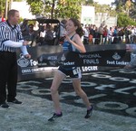 Aisling Cuffe crosses the finish line to win the Footlocker Cross Country National Championship.