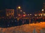 The crowd gathered in the village square before midnight.