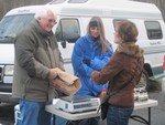 Janine Bixler picks up her meat order from Marty and Thelma Kiernan on the first sale day.