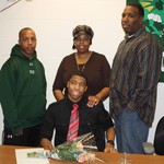 Tyree Smallwood, with his parents and coach Marcus Hughes.