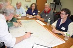 Local residents looked a maps and proposed alternative routes during the roundtable.