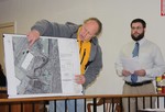Architect Vince Pietrzak shows a close-up of the plan for the warehouse expansion.