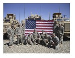 Lt. Dan Milliken (4th from left) took this photo with his unit in Afghanistan before sending the flag to be used in the Little League ceremony.