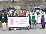 The 10-11 year-old softball champions carried their banner in the parade.