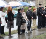 Family members and fellow officers stood in the rain during the ceremony.
