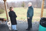 Councilman Clark and fellow dog owner Stacy Pskowski look out at the site of the proposed dog park in Angola Road Park.