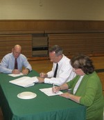 Superintendent Tmothy Rehm, Asst. Superintendent Harvey Sotland and School Board vice president Melanie Robinson go over the election results.