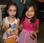 Kindergarteners Rachel Murphy and Elise Maldonado enjoyed chocolates.  Murphy's brother moved up earlier.