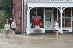 Randy Clark and some visitors to the flooded street outside Clark's office.