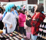 A young woman modeled a bright blue wig, one of hundreds of items for sale on Saturday.