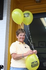 Ellen Kelly, owner of Smitchger Realty, blew up plenty of yellow blooms outside her business on Main Street.