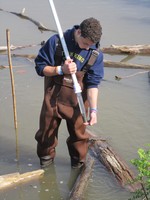 Storm King School senior Frank Conti gathers a sediment sample in the Hudson River.