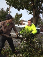 DPW Workers John Lewis and Tom Lyons remove fallen pear trees from Hudson Street Monday morning.