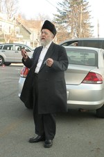 Samuel Marcus, owner of the building that houses the SImcha Candle Company, came to see whether his building had been destroyed.  Photo by Maureen Moore.