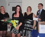 Tiffany Williams (l) presents a bouquet to Laura Lapre as Kristen Sebesta and Mike Bigg look on.