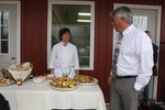 Donna Hammond offers some feta cheese quiche to Commissioner Aubertine.