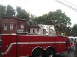 Photo by Jim Lennon. SKFE Co. #2 assists Newburgh FD.  82 Carson Avenue Fire Structure with Fire Department personnel on roof behind Newburgh Ladder Truck.