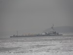 Photo by Jim Lennon. Tug pushing a barge load of petroleum product up the Hudson through heavy ice flow to Port Newburgh.