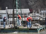 Photo by Jim Lennon. Yacht Club Members prepare docks for season.