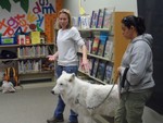 Maggie Howell, (Executive Director), Arctic Wolf 'ATKA' (Wolf Ambassador) and Rebecca Bose (Curator), of Wolf Conservation Center during 'Come and Meet ATKA the Wolf' at the exciting environmental education presentation at Cornwall Public Library, as audience (children and adults alike) listen and watch. 