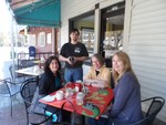 Hudson Street Cafe's customers Michelle Farr, Suzanne Toro and Margaret Vatter enjoy a sunny day sidewalk dining in Cornwall on Hudson, while Cody Woschol, a member of the Wait Staff, looks on.