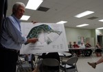 Photo by Jim Lennon. Cornwall Commons Developer Joe Amato, using expanded site display plan explains various aspects of the Development to attendees.