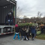 Photo by Oscar Rivas of Rivaucci. Lee Road students help load trees into the trucks for delivery.