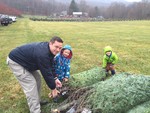 County Executive Steven M. Neuhaus helps Cooper Nannini and Ronan Rivas carry a Christmas tree at Tuesday?s ?Trees for Troops? donation drive at Farmside Acres in Cornwall. Cooper and Ronan are both 4-years-old. Their grandfather, Bob Nannini, owns Farmside Acres
