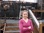Lisa stood outside the charred remains of her home